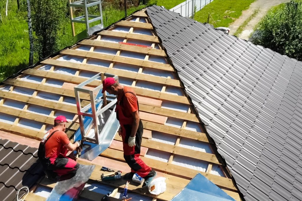 two workers installing metal roof service